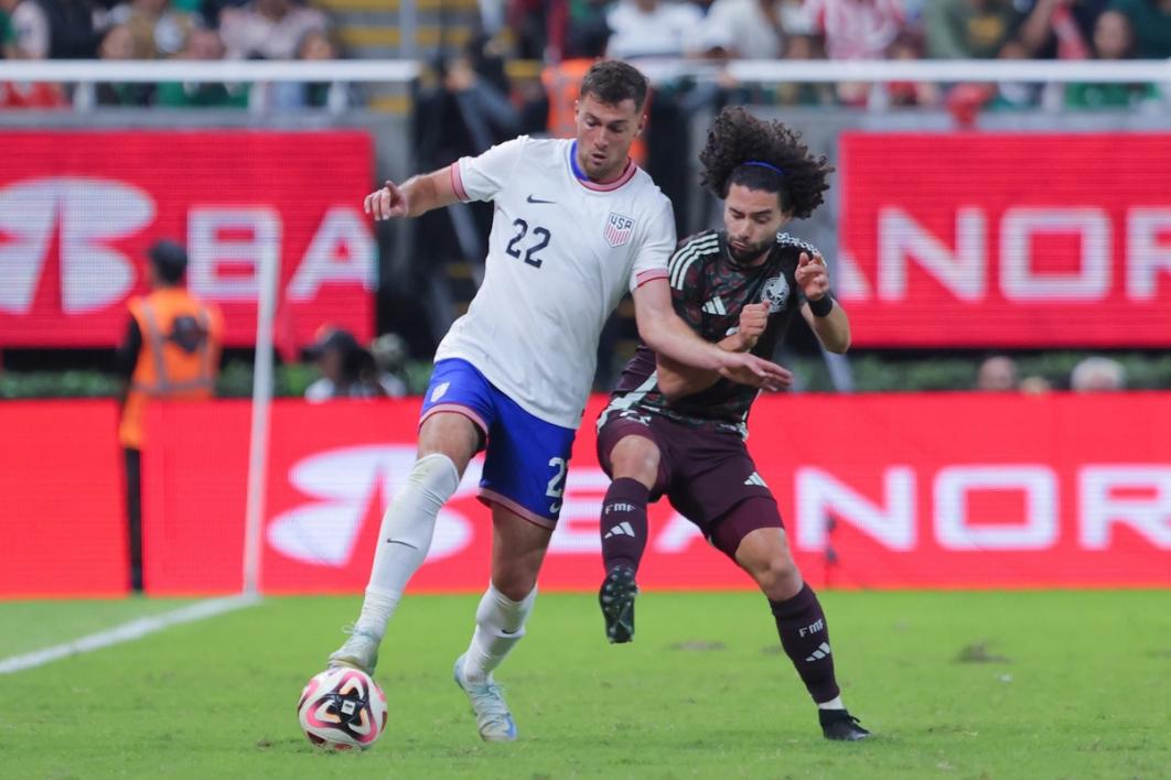 Joe Scally and a player for the Mexican National Team duel for the ball