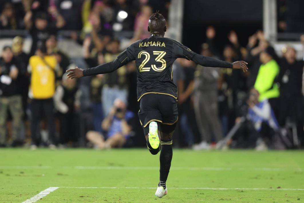 Kei Kamara runs away from the camera with arms outstretched celebrating a goal