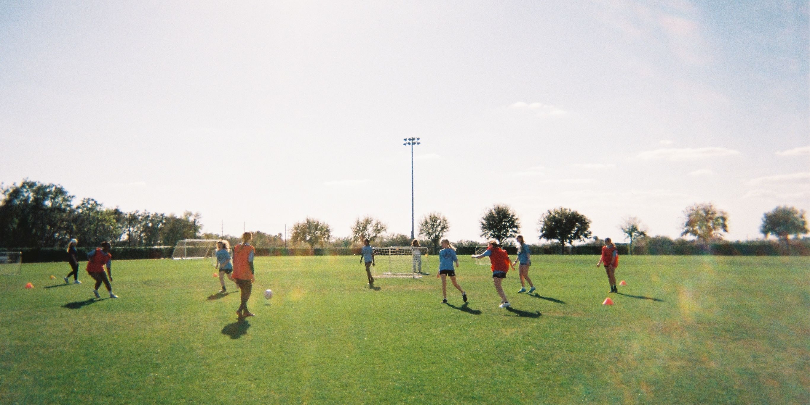 Girls participating in a group soccer lesson.