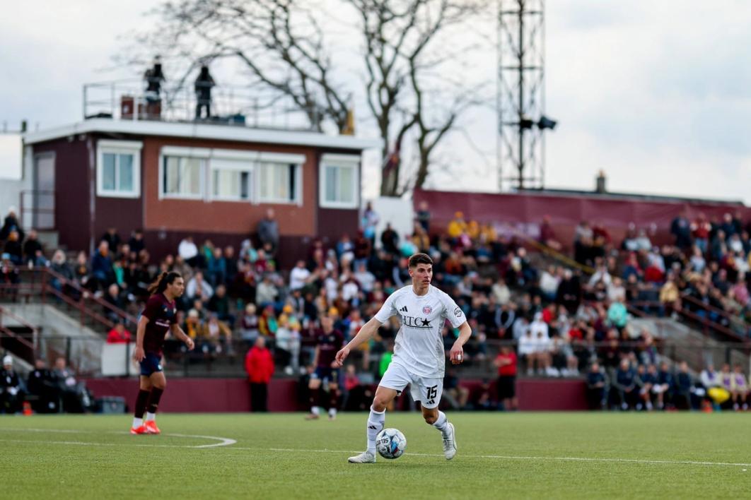 Soccer player with ball with Keyworth Stadium stands and pressbox in background