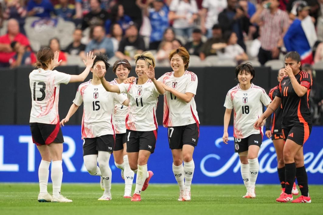 The Japan Women's National Team celebrates after scoring a goal against Colombia