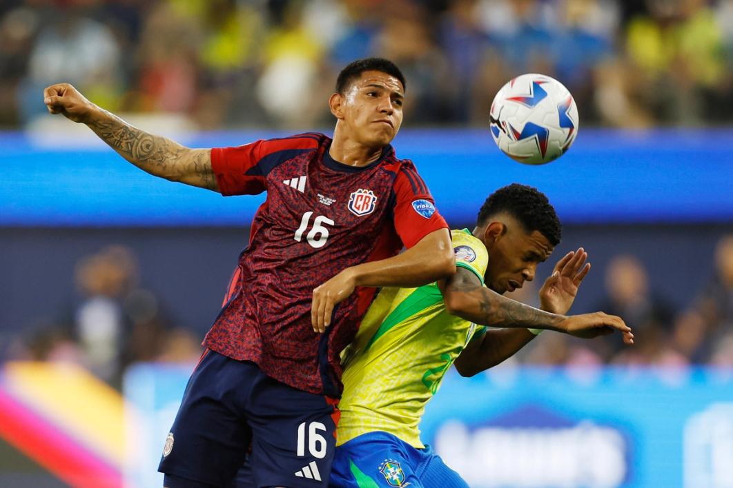 Costa Rica midfielder Alejandro Bran goes up for a headed challenge against Brazil