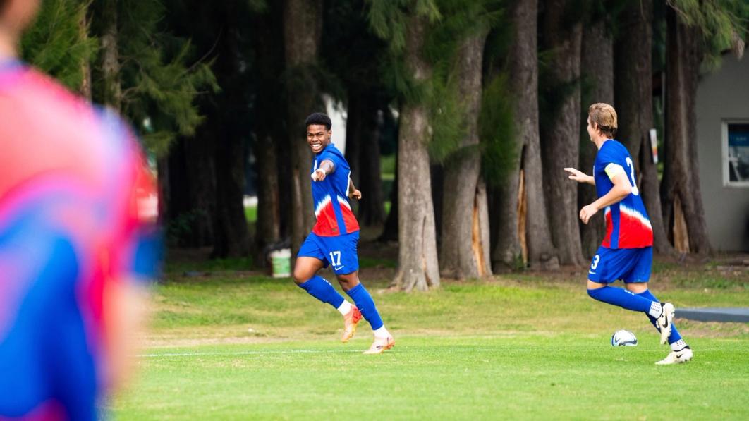 Keyrol Figeroa points and celebrates in a blue kit after scoring