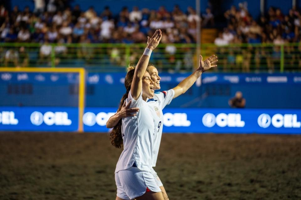 U.S. Women's Beach Soccer National Team players celebrate during a match