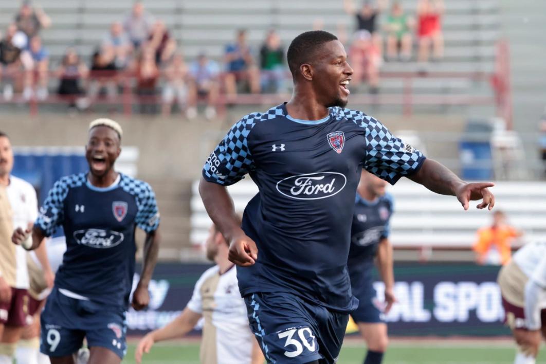 An Indy Eleven player celebrates on the field with his left finger pointing forward