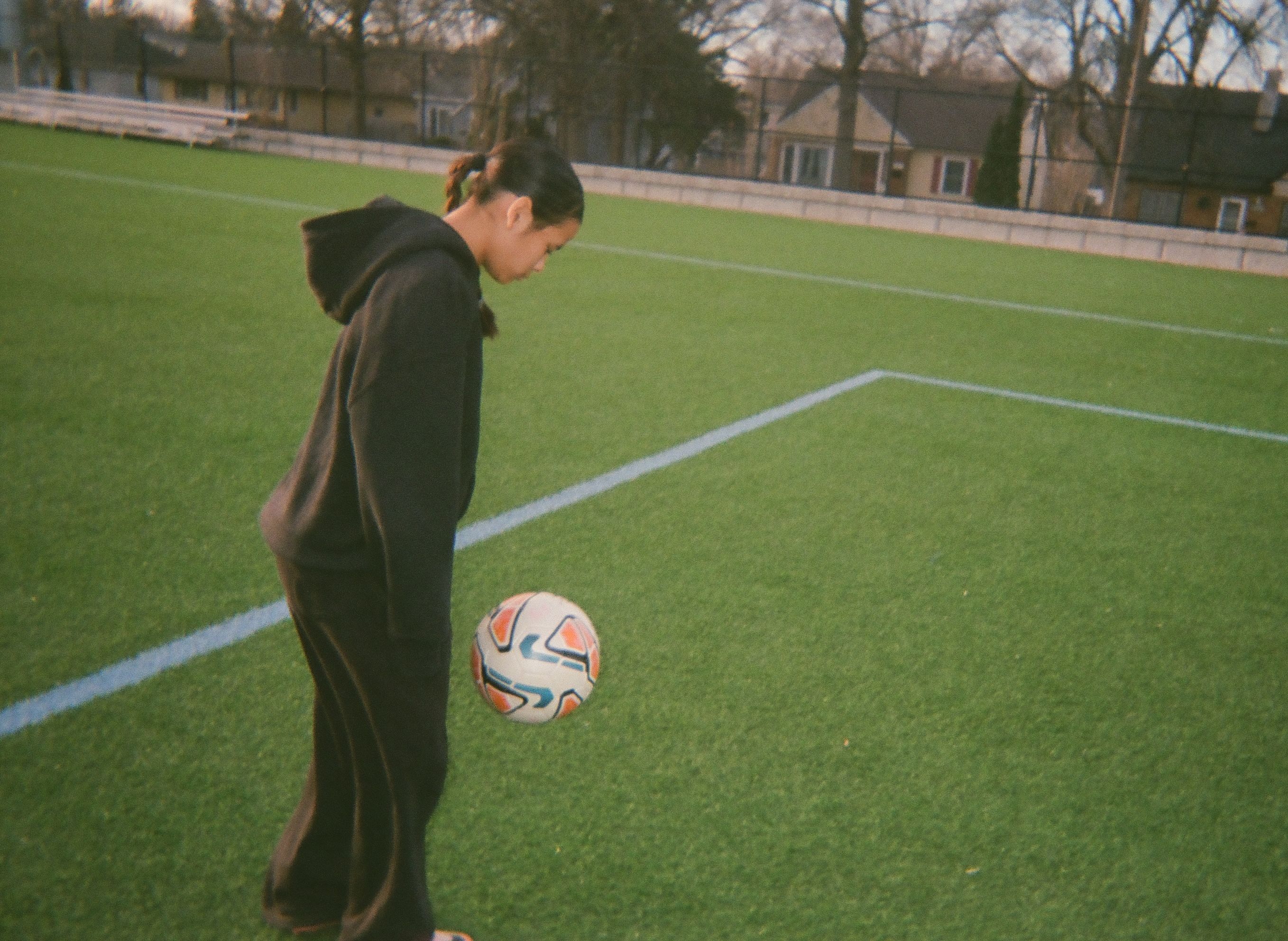 A girl practicing soccer skills.