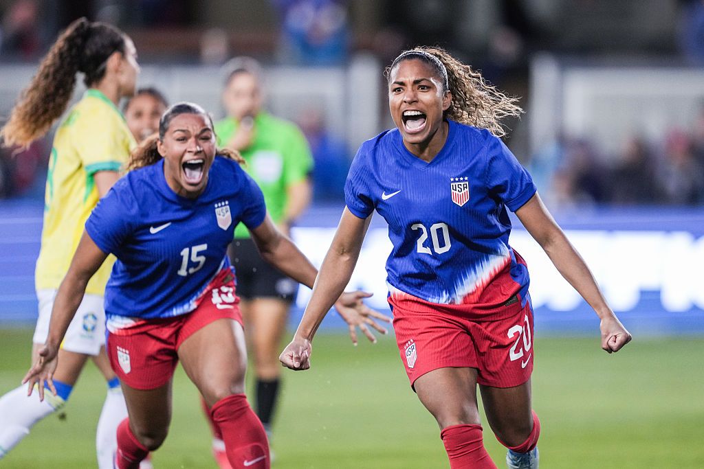 Catarina Macario running and shouting in celebration after scoring a goal