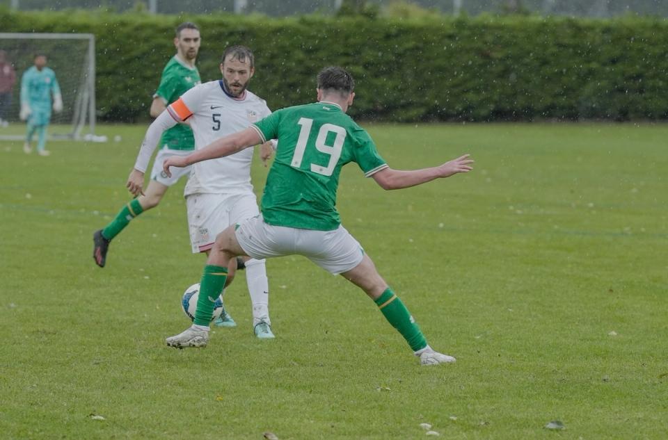 John Sullivan dribbles around an Ireland defender