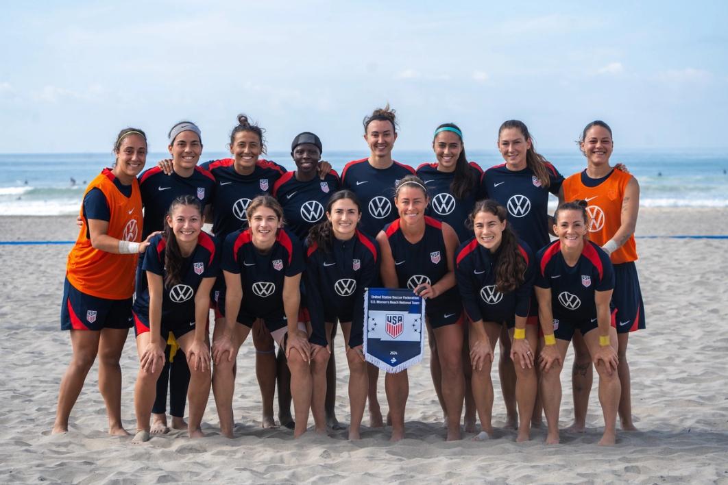 Players for the US Women's Beach National Team pose for a team photo on a beach