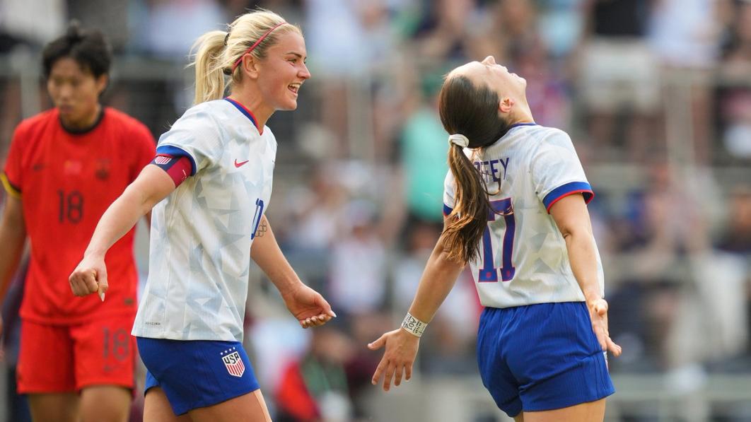 Lindsey Heaps and Sam Coffey celebrate Coffey's goal
