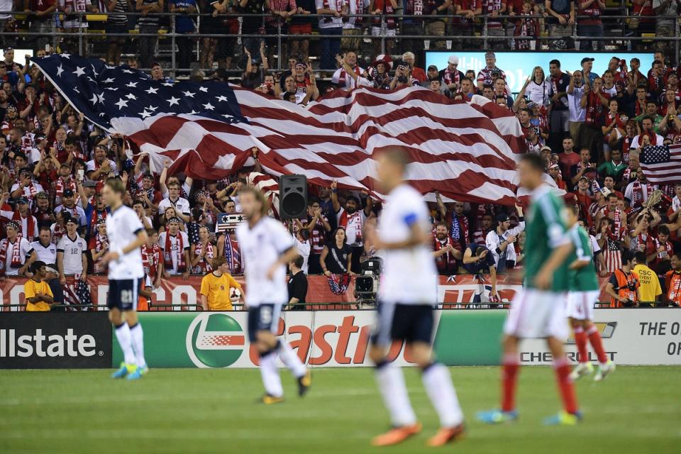 Fans unfurl a large U.S. flag after the USMNT scored their second goal against Mexico in the second half at Columbus Crew Stadium on September 10, 2013 (Photo by Jamie Sabau/Getty Images)