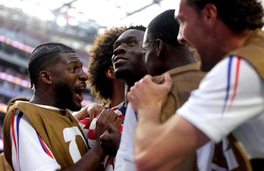 Folarin Balogun surrounded by his teammates after scoring against Paraguay