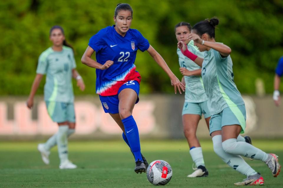 Yuna McCormack dribbles the ball up the field during a match