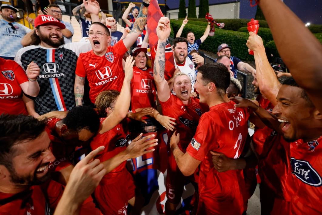 Indy Eleven players celebrate a win over Atlanta with fans in the stands