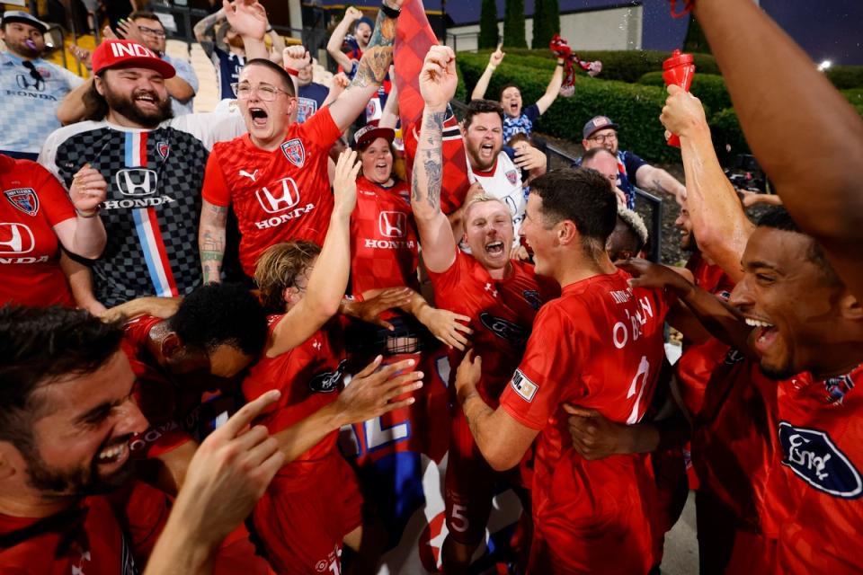 Indy Eleven players celebrate a win over Atlanta with fans in the stands