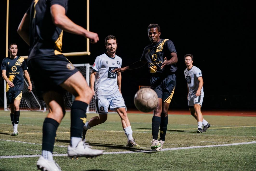A player passes the ball back to a teammate during an Open Cup match