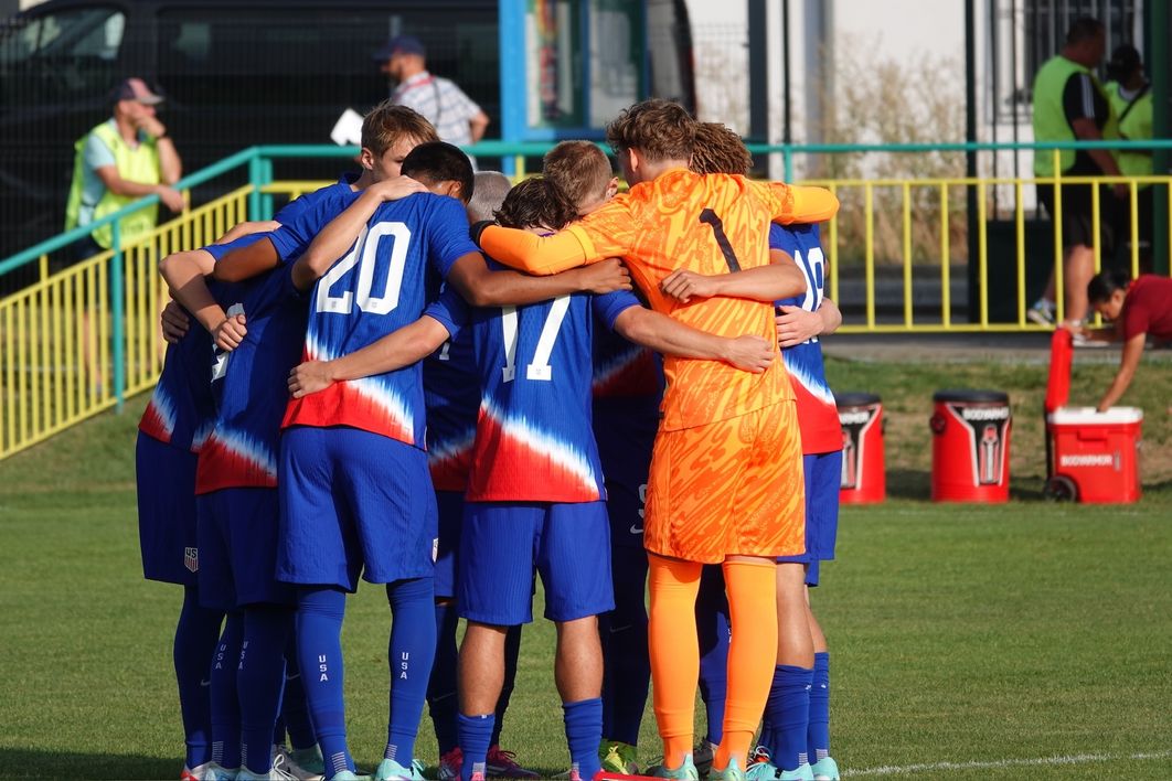 The U-17 MYNT huddles up on the field