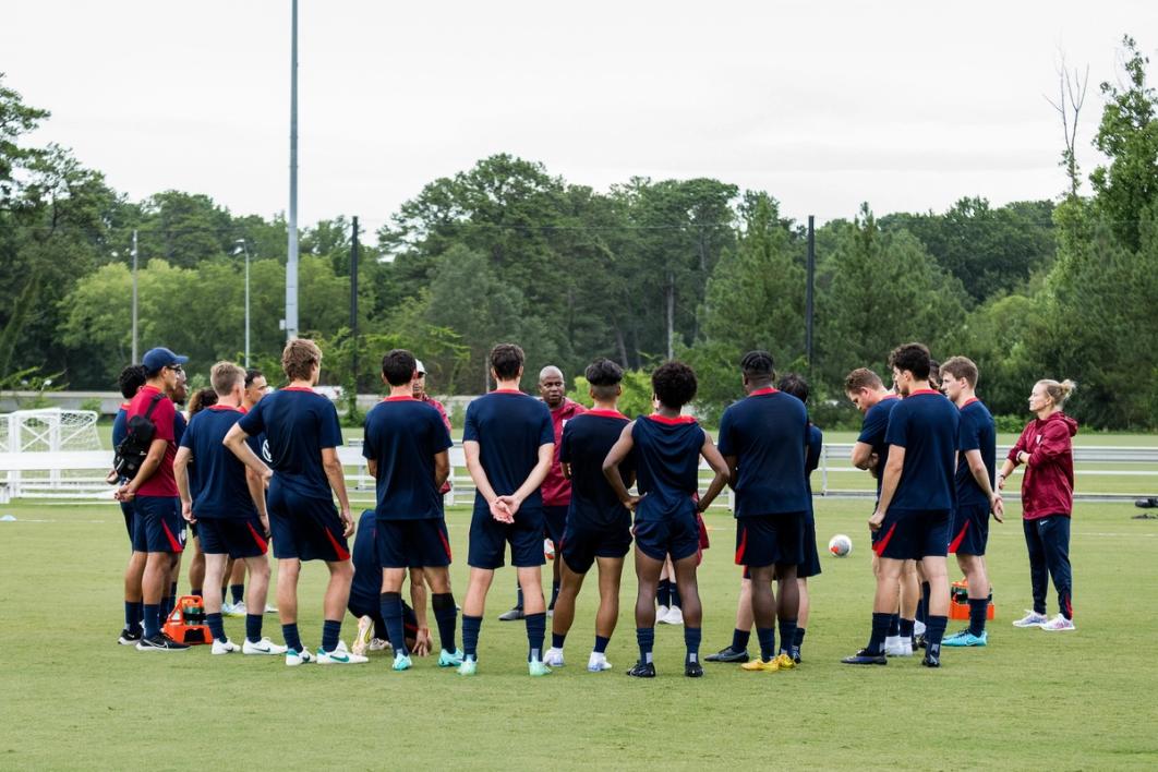 The U.S. Men's Deaf National Team huddles up on the field during a training session