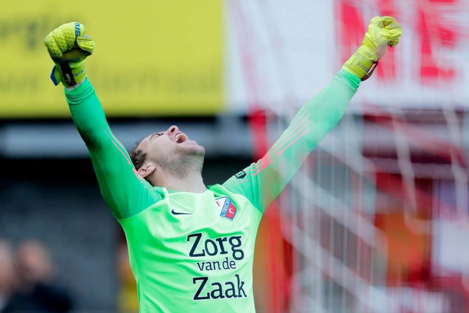 Maarten Paes celebrates with his arms in the air while playing for FC Utrecht