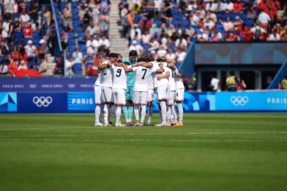 The U.S. Men's Olympic Soccer Team huddled on the field against Morocco