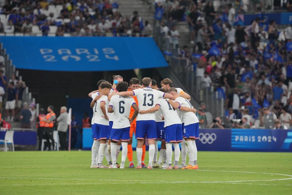 The US Olympic Mens National Team huddles on the field during its opening match against France