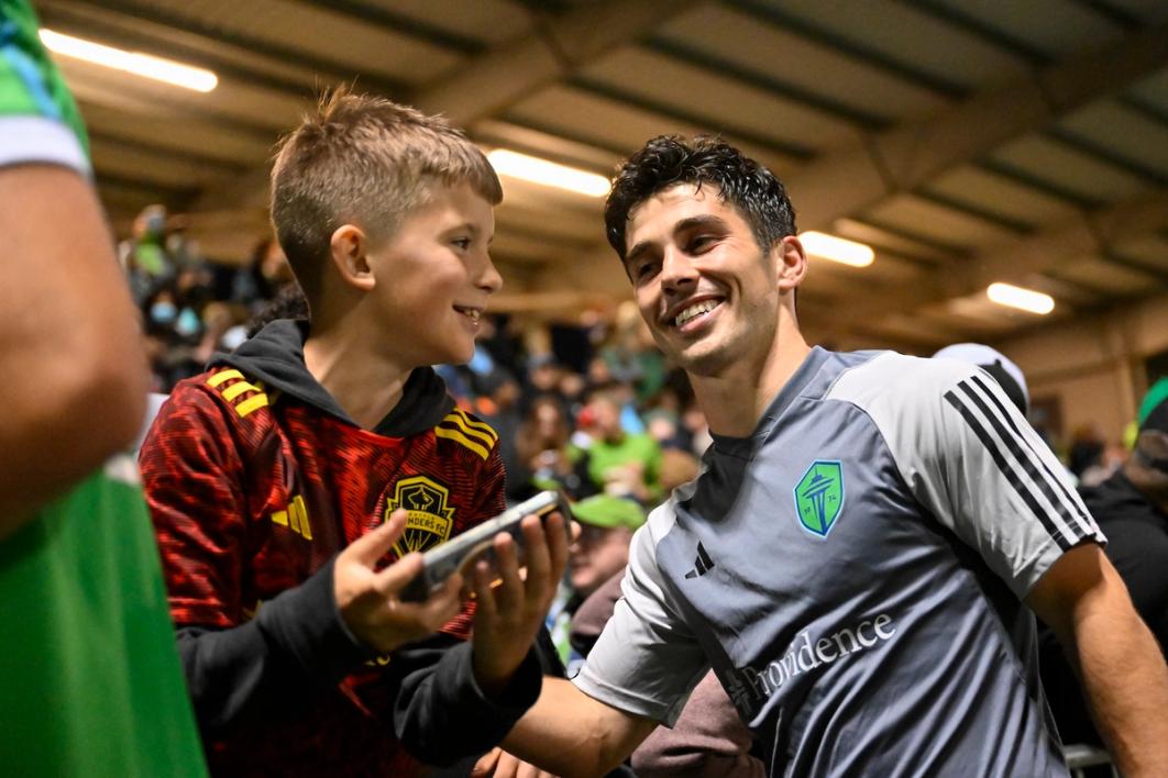 Rothrock gets ready to take a picture with a young fan