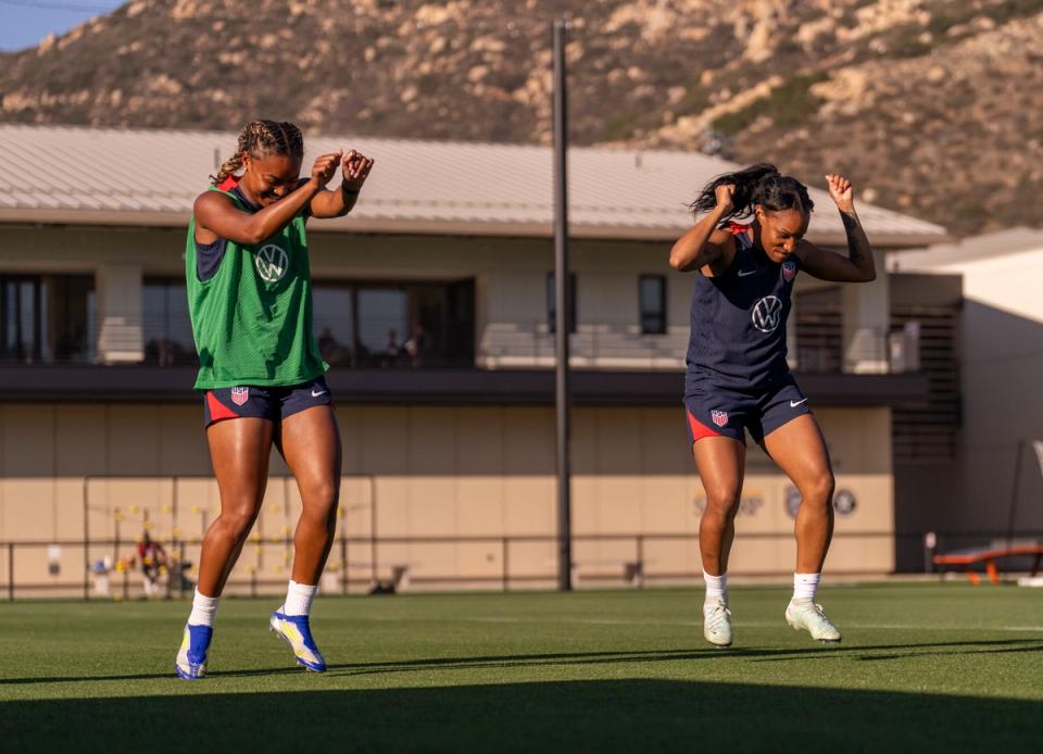 Crystal Dunn dances with Jaedyn Shaw