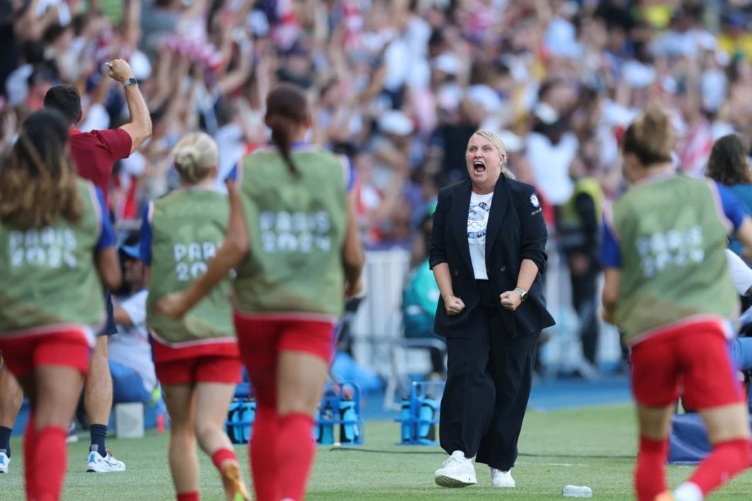 Emma Hayes yells in celebration towards the USWNT bench