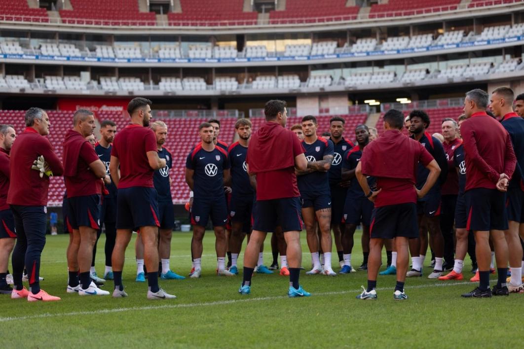 Staff and players of the U.S. Men's National Team huddle up on the field