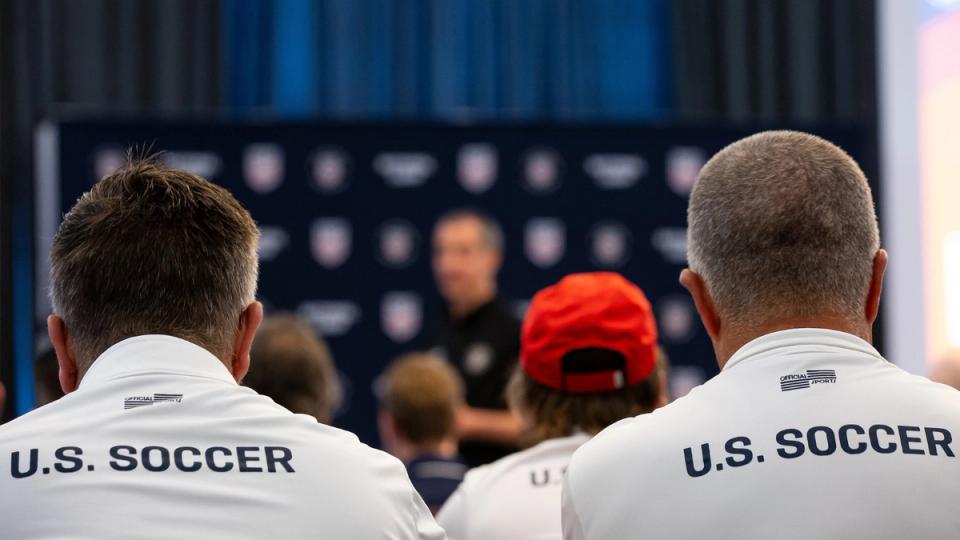 U.S. Soccer Refereeing staff and National Referee Coaches gathered in a ballroom session.