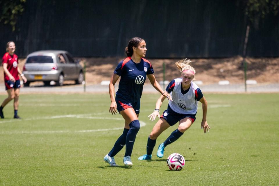 Jordyn Bugg dribbles the ball around a defender at training