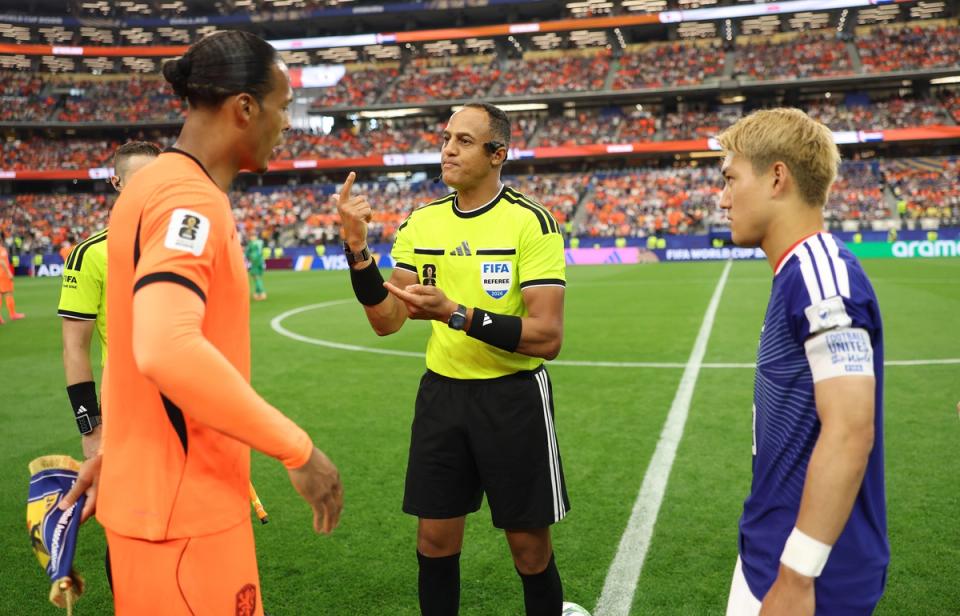 Referee Ismail Elfath conducts the coin toss before the FIFA World Cup match between Netherlands and Japan (Photo by Maja Hitij - FIFA/FIFA via Getty Images)