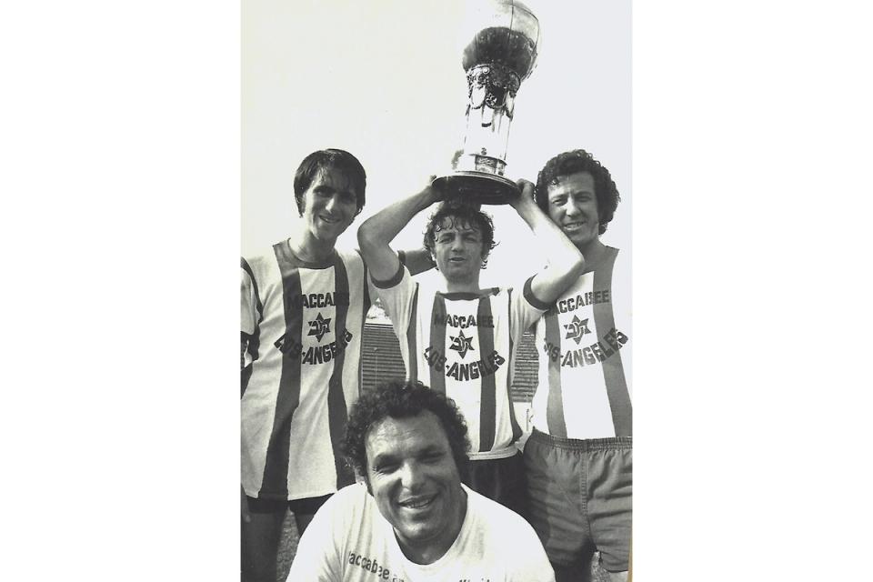 Benny Binshtock holds the Dewar Cup (the original Open Cup trophy) with fellow Maccabees 