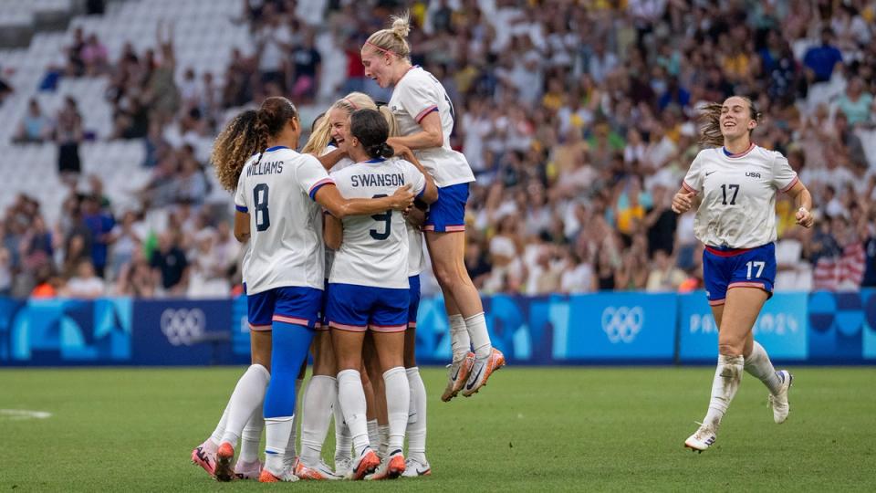 USWNT players celebrate Korbin Albert's goal against Australia in the final match of the Olympic group stage.