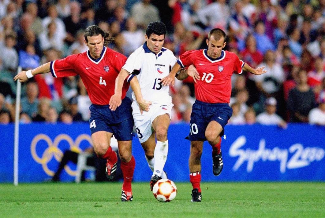 Two U.S. Olympic Soccer Players challenge an opponent for the ball