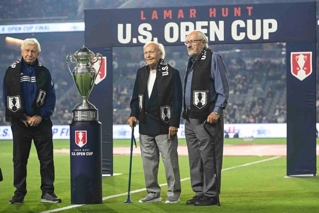 Members of the 1950 and 1960s LA Kickers stand at midfield with the US Open Cup trophy prior to kickoff