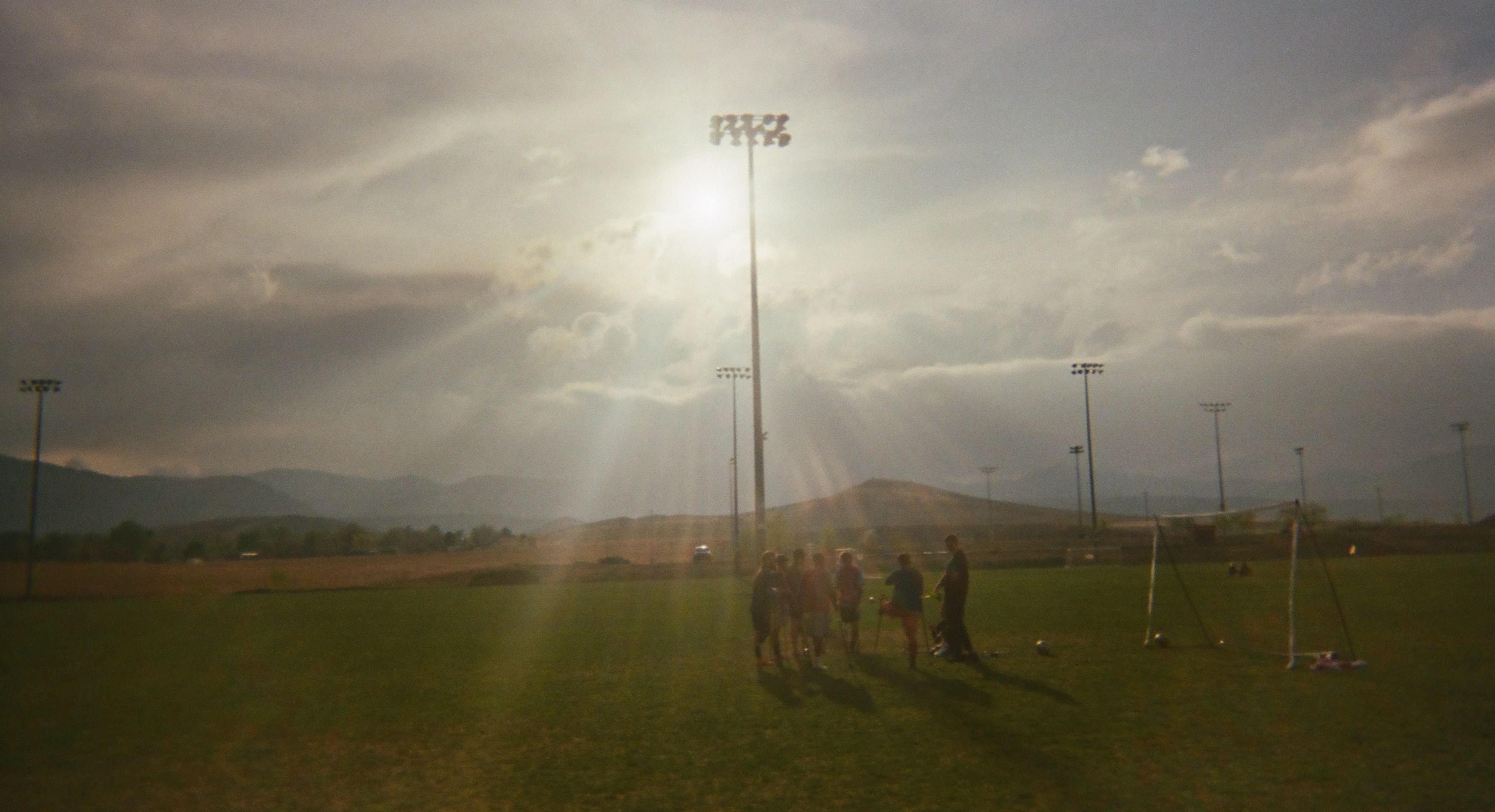 Amputee soccer players gathered on a field during training.
