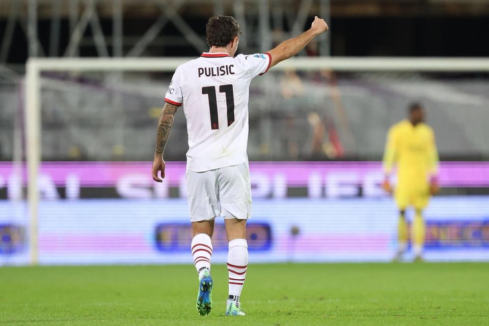 A photo behind Christian Pulisic celebrating for AC Milan