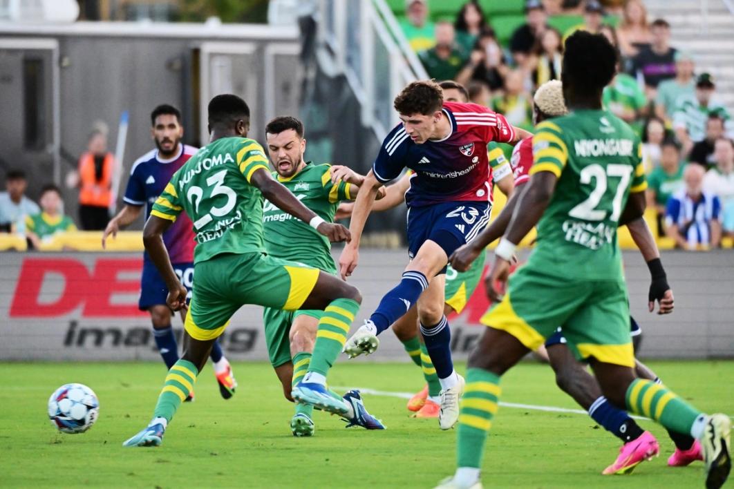 FC Dallas player takes a shot surrounded by Tampa Bay Rowdies players