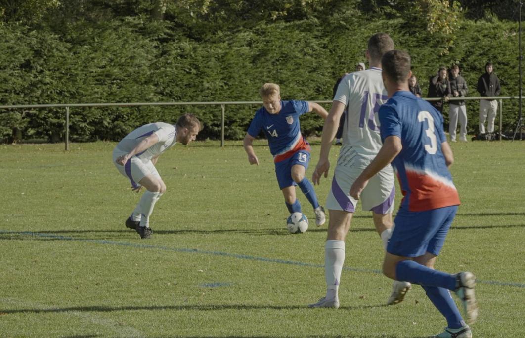 Shea Hammond dribbles the ball towards goal in a match against Scotland