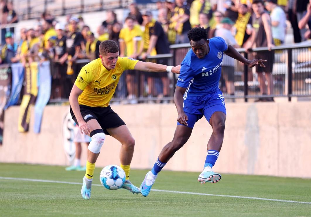 An App FC player dribbles the ball during a match