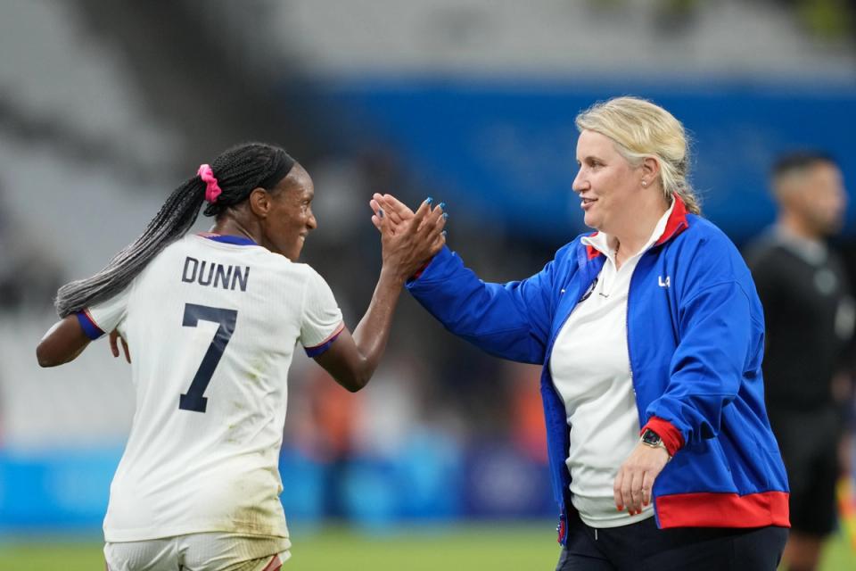 Crystal Dunn high-fives Emma Hayes