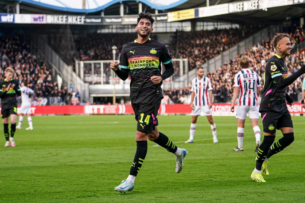 Ricardo Pepi smiles while running at midfield for PSV Eindhoven