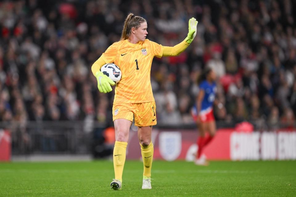 Alyssa Naeher holds the ball during a match against England