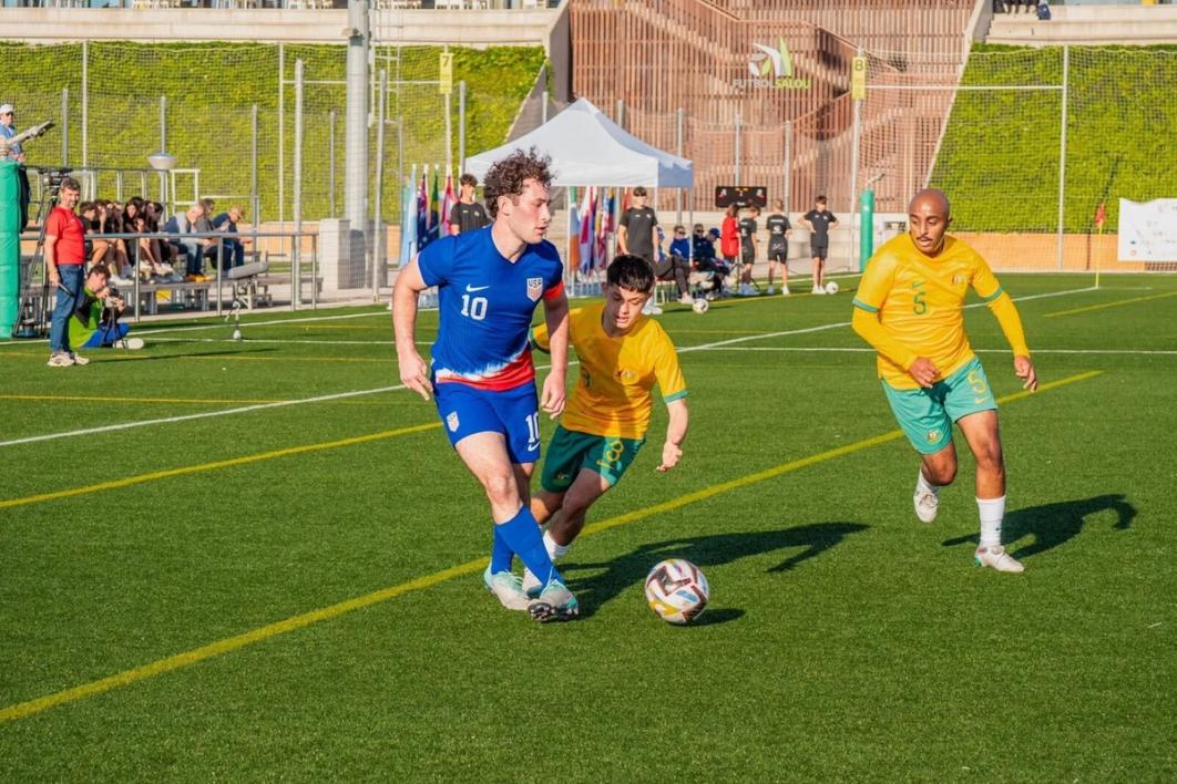 Ben Lindau dribbles the ball forward against Australia