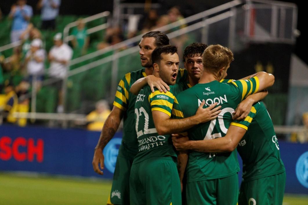 Five Tampa Bay Rowdies players huddled up during a match