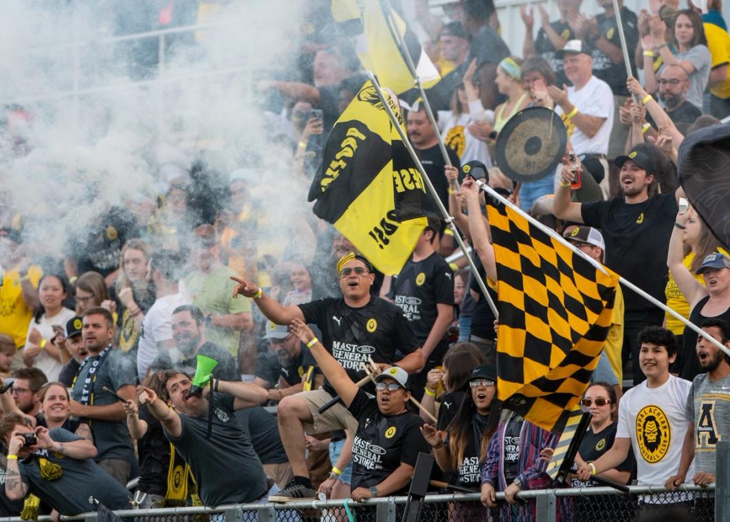 App FC fans wave flags and cheer from the stands