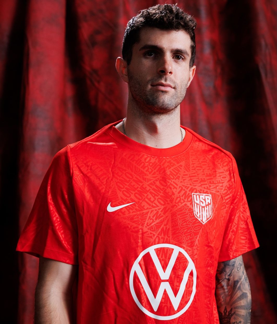 Christian Pulisic wearing orange prematch top