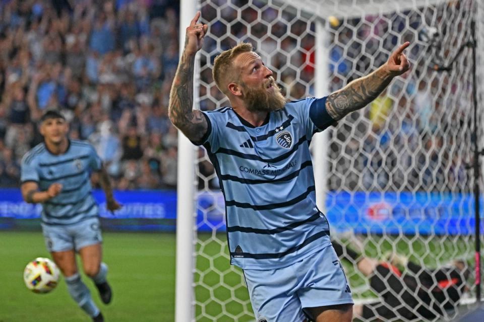 Johnny Russell points to the crowd in celebration