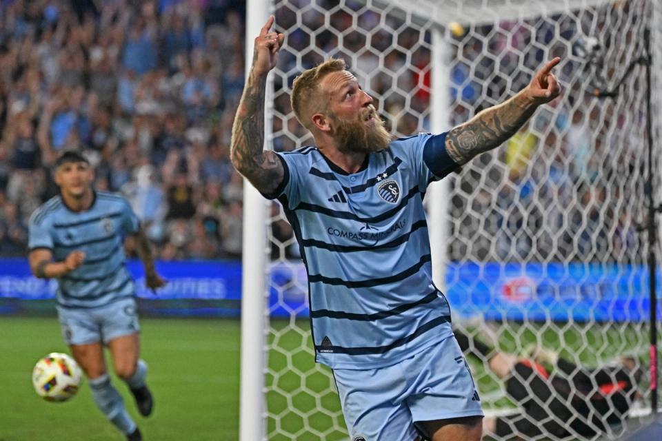 Johnny Russell points to the crowd in celebration